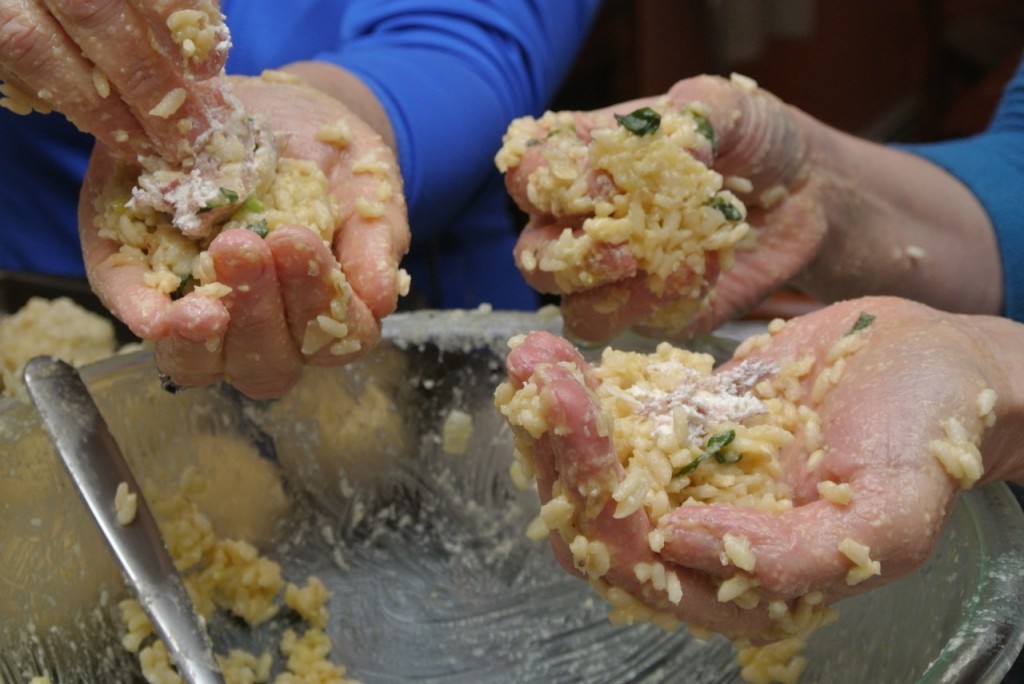 Getting your hands dirty - forming arancini. Italiaoutdoorsfoodandwine bike tours italy